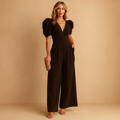 Woman wearing an elegant long jumpsuit with a tailored silhouette and flowing design, suitable for formal events, dinners, and upscale occasions.