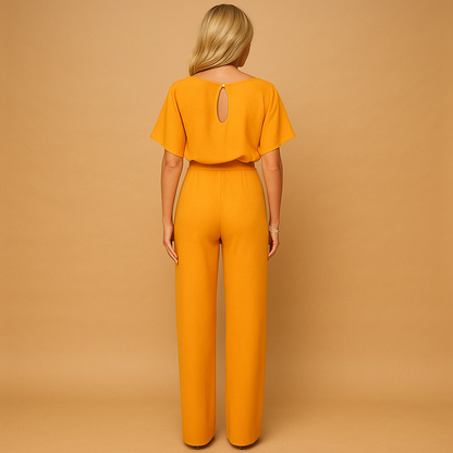 Woman wearing a high-waist lace-tie jumpsuit with a flattering tailored fit and soft draping fabric, suitable for work, evenings out, and chic casual occasions.