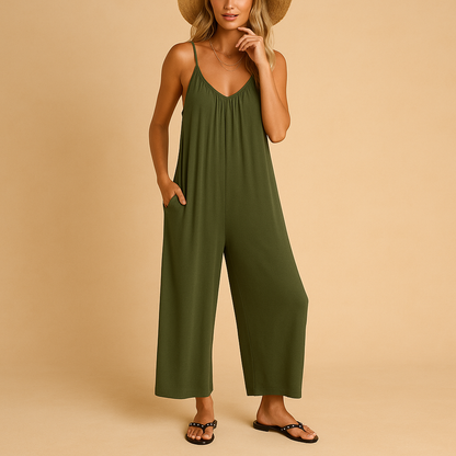 Woman wearing a loose summer jumpsuit with adjustable straps and an elastic waistband, ideal for holidays, parties, and warm days.