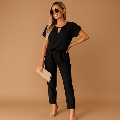 Woman wearing a tailored elegant jumpsuit with a flattering fit, suitable for business, formal dinners, and stylish evening occasions.